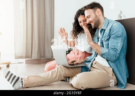 Engaged couple make having fun while making a video call with friends and family Stock Photo