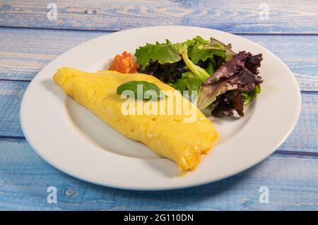 Omelette with salmon and herbs, served on plate, traditional Norwegian dish Stock Photo
