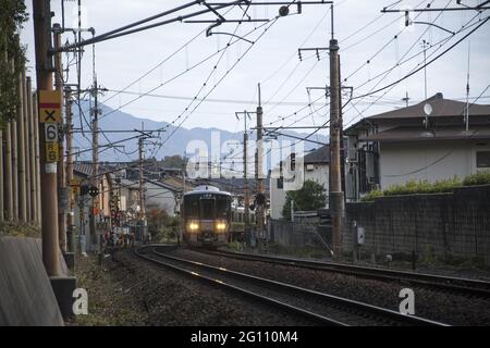 KYOTO, JAPAN - Dec 11, 2019: Kyoto, Japan-26 Nov, 2019: Sagano local train pass through Arashiyama in the autumn. Stock Photo