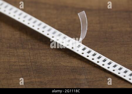 Electronic components: smd resistors on paper tape. Two-terminal passive components. Stock Photo