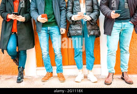 Group of friends using smart phone app - Teen addiction to new technology trends - Concept of alienation, technology and friendship - Focus on middle Stock Photo