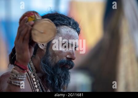 Haridwar, Uttarakhand, India April 12, 2021. Indian Saints in their traditional way of Yog Mudra, meditating. Sitting in silence as part of the initiation of new sadhus during Kumbha Mela. The Naga Sadhus.  Stock Photo