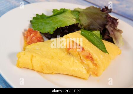 Omelette with salmon and herbs, served on plate, traditional Norwegian dish Stock Photo
