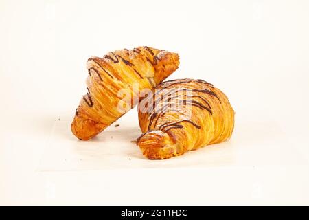 Chocolate filled brioche croissant flaky made in butter isolated on white background Stock Photo