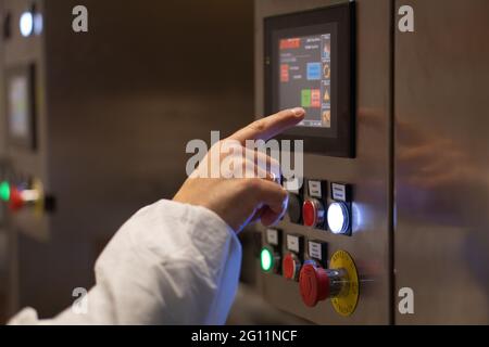CAPUA, ITALY - Jun 03, 2021: Engineer operating touch computer in industrial plant in Capua, Italy, Jun 03th 2021. Stock Photo