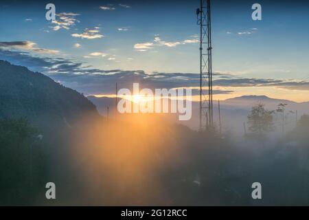 Sun rise behind Himalayan Mountains - shot from inside of a glass window using light flares and colours capturing the beauty of cold environment. Stock Photo