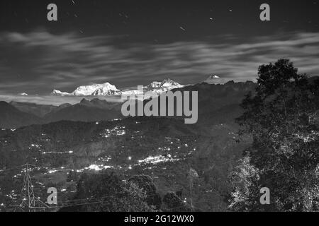 Beautiful last light from sunset on Mount Kanchenjugha, Himalayan mountain range, Sikkim, India. color tint on the mountains at dusk - black and white Stock Photo