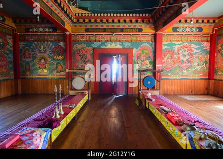 Rinchenpong, Sikkim, India - 17th October 2016 : One young Lama opening the door and bringing in light inside prayer room at Rinchenpong monastery , w Stock Photo