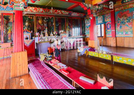 Rinchenpong, Sikkim, India - 17th October 2016 : One young Lama inside Rinchenpong monastery in the prayer room with decorated murals on the walls. Stock Photo