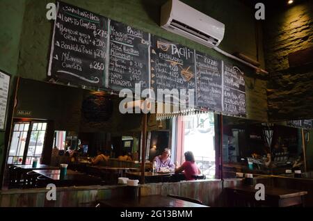 Buenos Aires, Argentina - January 2020: Cafe interior with mirrors on walls and blackboard with menu written in chalk. Interior of cozy restaurant Stock Photo