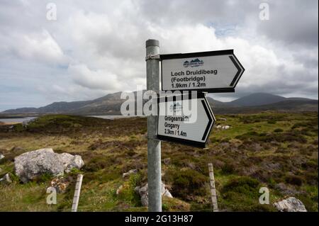 Hebridean Way sign at Loch Druidibeag nature reserve in South Uist. Blurred background of rural landscape and mountains. Sunny day, no people. Stock Photo