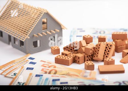 Bricks and house model construction with Euro money Stock Photo
