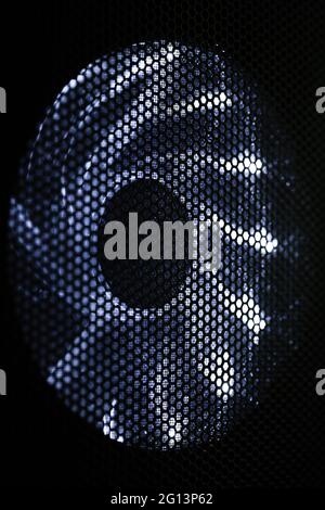 Illuminated PC cooler fan in black desktop case, front view Stock Photo