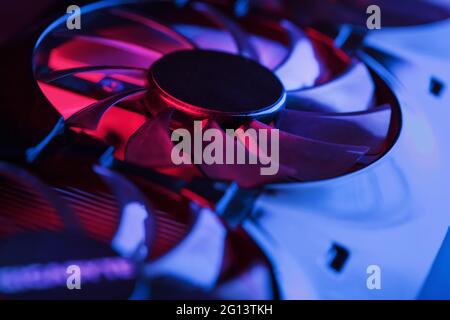 A close-up video card fan with cyanide magenta illumination in a futuristic style. Powerful gaming graphics card for video games and cryptocurrency mi Stock Photo
