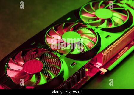 Coolers of the Gaming Video Card in red and green neon light. High-tech GPU for gaming and mining of crypto farms Stock Photo