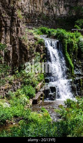 Summer background with waterfall stream among rocks Stock Photo