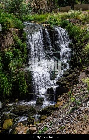 Summer background with waterfall stream among rocks Stock Photo