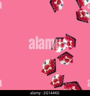 cakes fall from top to bottom on the pink background on the right. Space for text and advertising. flat flay with copy space Stock Photo