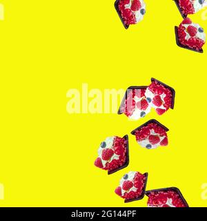 cakes fall from top to bottom on a yellow background on the right. flat flay Stock Photo