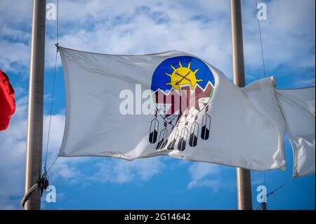 Treat 7 Flag in Alberta at half mast, blue sky background. Stock Photo