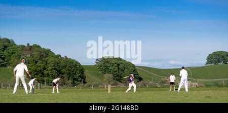 Wensleydale, UK. 04th June, 2021. 4 June 2021 - Hawes, North Yorkshire - Village cricket in what has to be one of the most scenic little grounds as Hawes bat on their home ground at Haylands on the banks of the River Ure. Credit: Wayne HUTCHINSON/Alamy Live News Stock Photo