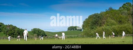 Wensleydale, UK. 04th June, 2021. 4 June 2021 - Hawes, North Yorkshire - Village cricket in what has to be one of the most scenic little grounds as Hawes bat on their home ground at Haylands on the banks of the River Ure. Credit: Wayne HUTCHINSON/Alamy Live News Stock Photo