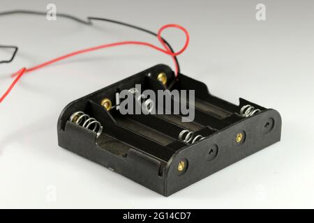 Battery holder AA. Holder for four batteries. Electronic components. Stock Photo