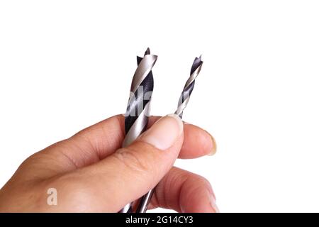 Hand holds two drill bits isolated on white background close up Stock Photo