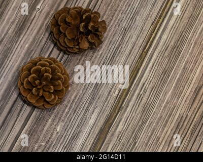 pine cones scattered on wooden background Stock Photo
