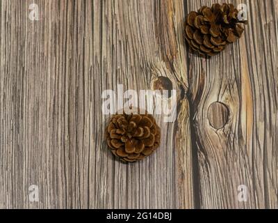 pine cones scattered on wooden background Stock Photo