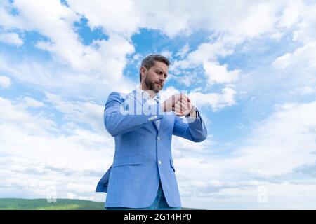 mature businessman in formalwear. business success. man in blue suit and wristwatch. Stock Photo
