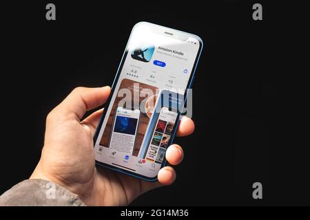 Kharkov, Ukraine - June 4, 2021: Amazon kindle app, man holds mobile phone with application on screen Stock Photo