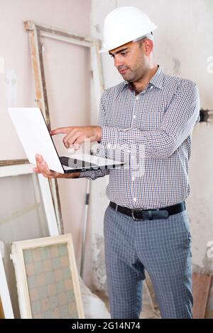 Man engineer managing process with laptop Stock Photo