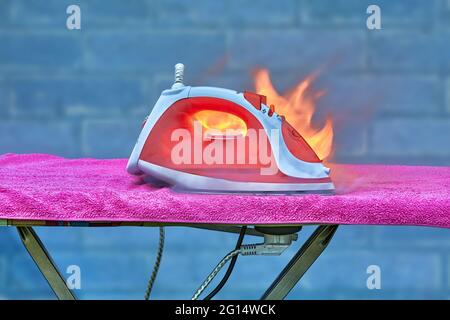 Fire caused by faulty home appliance destroyed property. Stock Photo