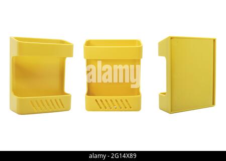 Wall mounted yellow plastic organizer rack in three positions isolated on white background. Useful for mobiles, remote controls, office objects and ot Stock Photo