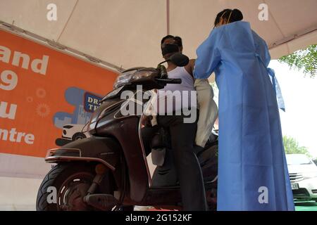 New Delhi, India. 03rd June, 2021. Resident with his own vehicle gets inoculated against covid-19 during a drive in vaccination facility for 18 above people at Moolchand Hospital in Delhi. (Photo by Ishant Chauhan/Pacific Press) Credit: Pacific Press Media Production Corp./Alamy Live News Stock Photo