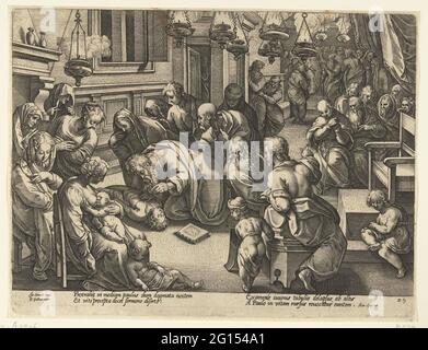 Paul generates eutychus; History of the apostles. In a room full of people, lit with oil lamps, Paul kneb down at a boy who lies on the floor on his back. Under the show four lines of Latin. This print is part of a 36-part set of prints of the history of the apostles. Stock Photo