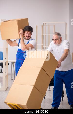 Two professional movers doing home relocation Stock Photo