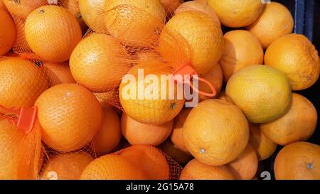 Mandarin oranges put in a mesh bag to be sold in the market. Stock Photo