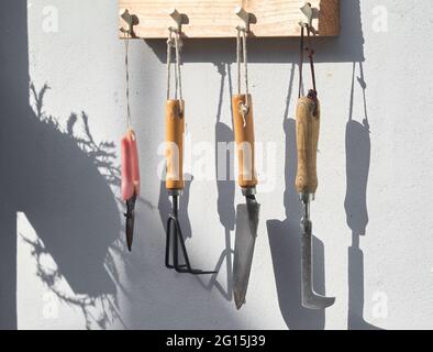 Gardening tools hanging on a rope Stock Photo