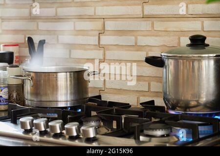 We cook sorrel in metal saucepan according to the recipe from the Internet for lasagna with goat cheese Stock Photo