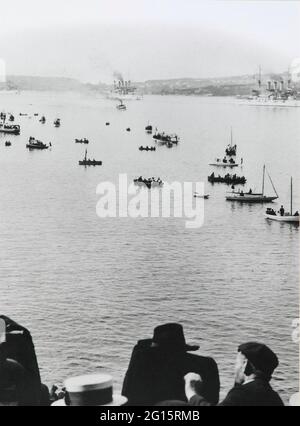 THE 1908 AMERICAN FLEET IN SYDNEY HARBOUR *** Local Caption *** PHOTOGRAPH  THE 1908 AMERICAN FLEET IN SYDNEY HARBOUR  Photograph.  Untitled (the 1908 american fleet to sydney harbour).  Sydney, australia, 1908.  Silver gelatin print, paper.  The black and white image depicts the Great White Fleet in sydney harbour steaming past crowds of spectators.  The fleet appears at upper c. People watch the fleet from small craft, longboats and skiffs, at c.  The heads of several people appear at l.L. Corner and bot. C. Perhaps watching the fleet from a ship.