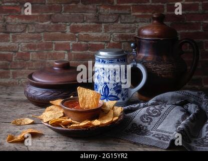 Nachos with salsa sauce on a wooden table Stock Photo