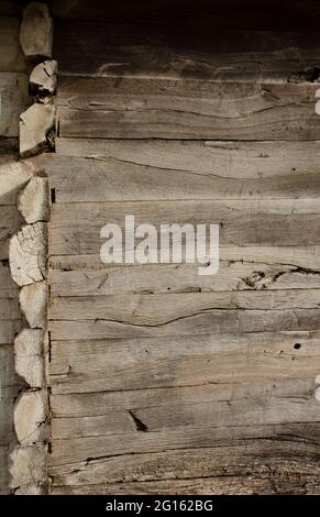 A close-up of corner joint of wooden house - joining wooden beams. The corner of an old wooden hut built completely without nails. Only on the self-co Stock Photo