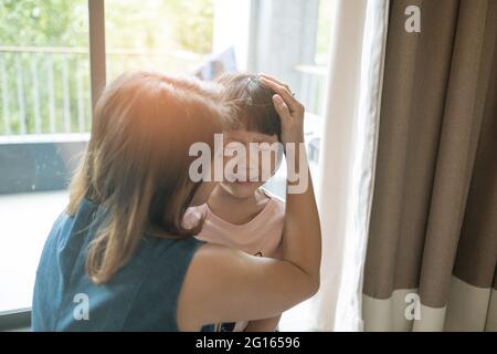 mother hit her kid, children crying, feeling sad, young girl unhappy, family violence concept, selective focus and soft focus Stock Photo