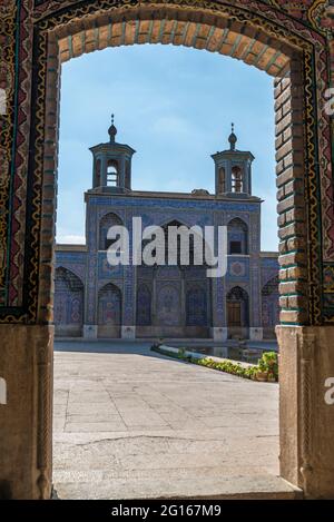 Courtyard of the Nasir ol-Molk mosque (Pink Mosque) seen from one of the door openings. Shiraz, Fars Province,  Iran Stock Photo