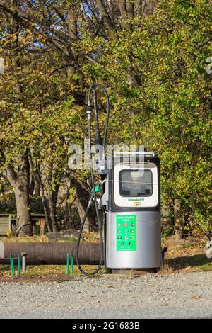 An old Mobil petrol pump dating back to sometime in the 1990s standing alone beside the road in the village of St Bathans, New Zealand Stock Photo