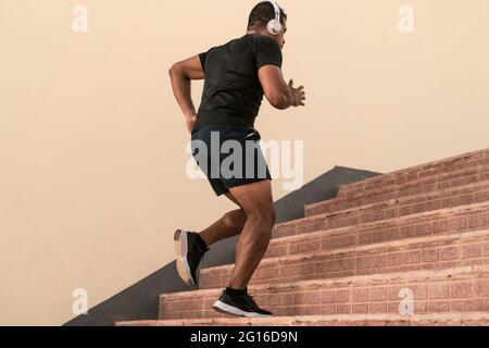Fit man doing running exercises on stairs outdoor - Sporty people lifestyle concept Stock Photo