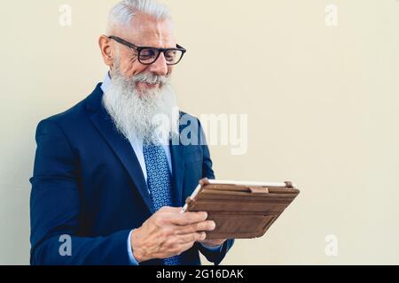Senior business man working on digital tablet outdoor - Entrepreneurship and technology concept Stock Photo