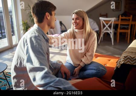 A young couple in love having a lovely talk in a relaxed atmosphere at home. Couple, love, home, relationship Stock Photo